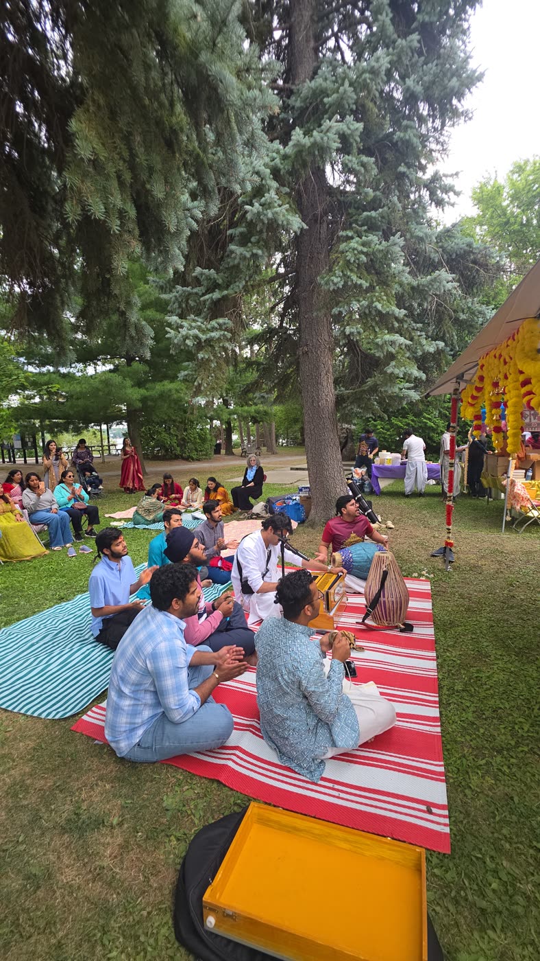 Devotees and guests seated together in the park
