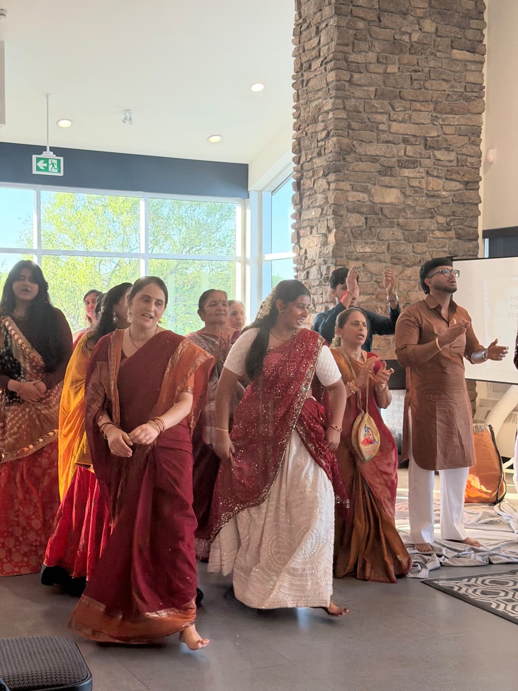 Devotees dancing in the kīrtana